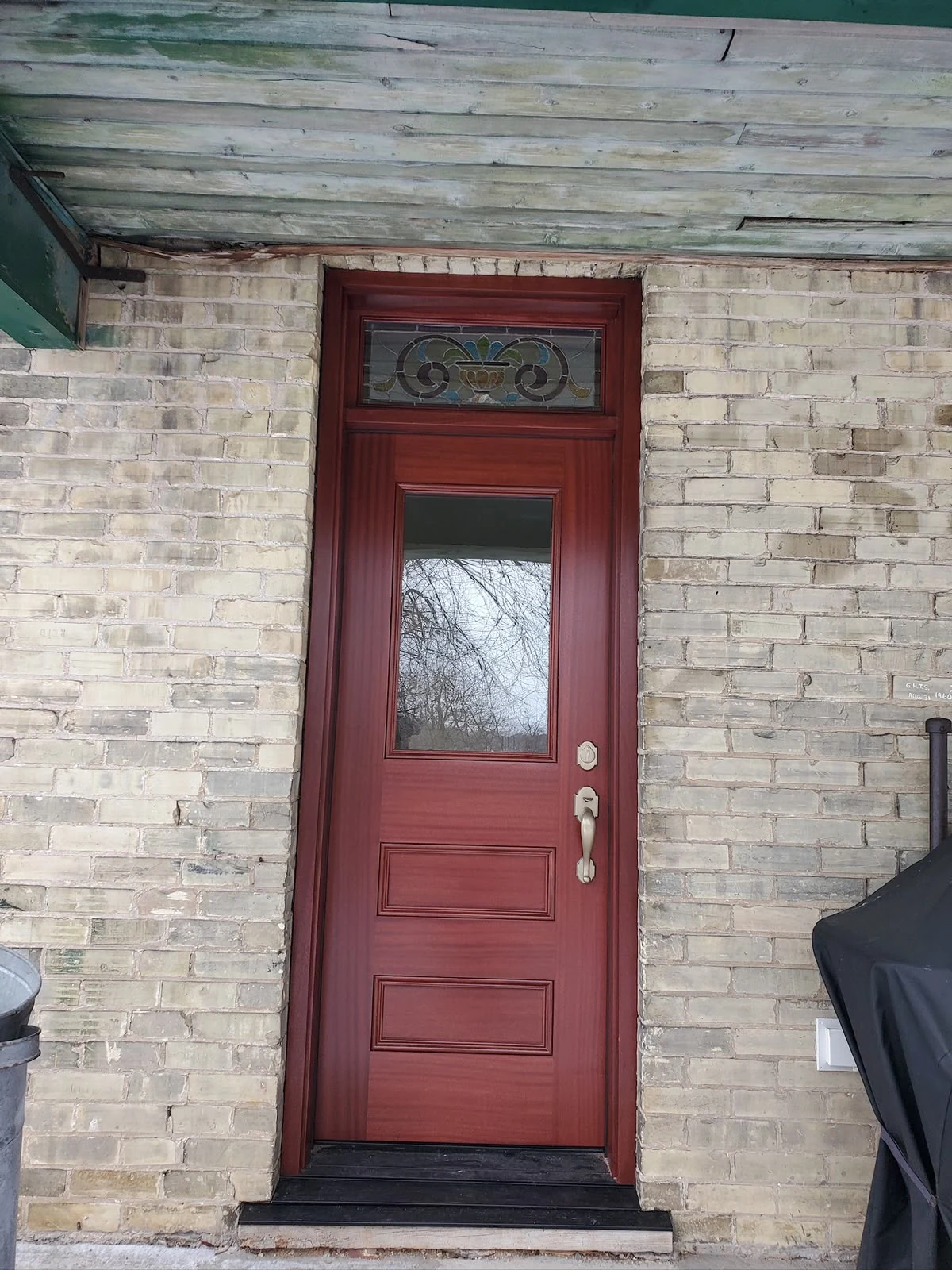 Red entry door with decorative transom
