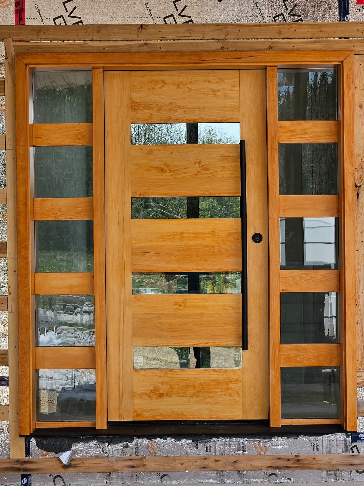 Contemporary wood exterior entry with horizontal glass panels